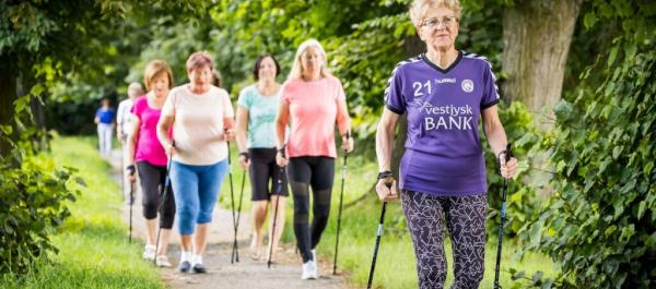 zdjęcie kilka starszych pań uprawia nordic walking w park